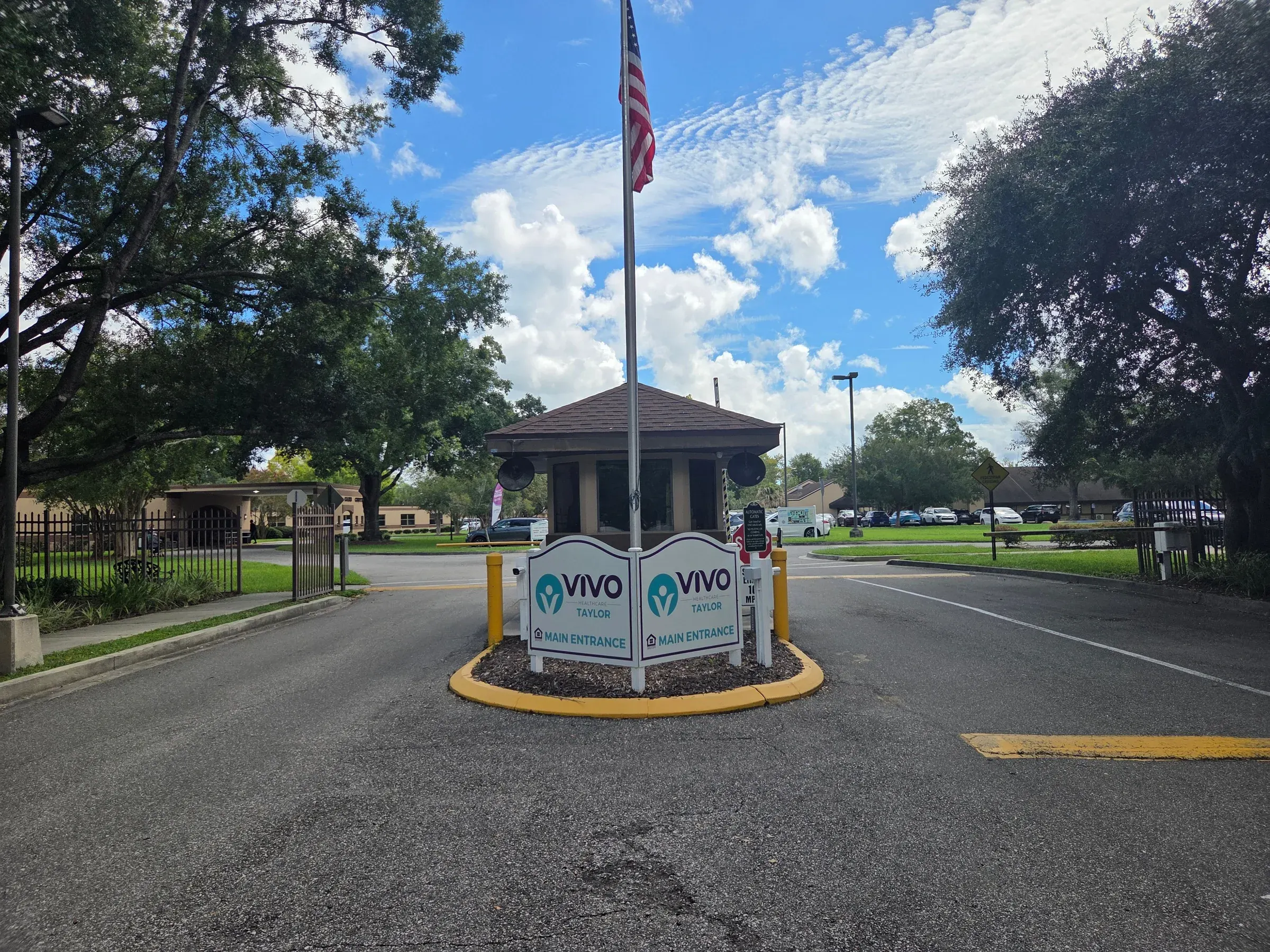 The main entrance at Vivo Healthcare Taylor, gatehouse and flag on the approach